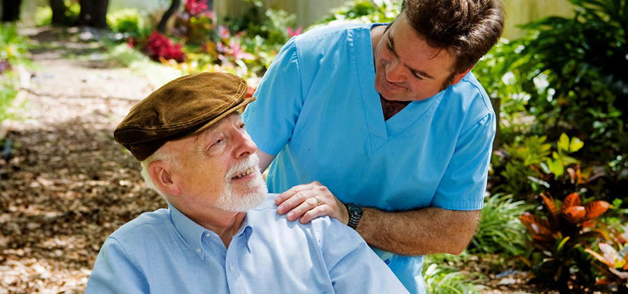 elderly man and younger carer